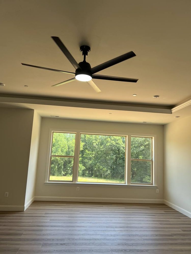 Ceiling fan mounted and wired in a residential room