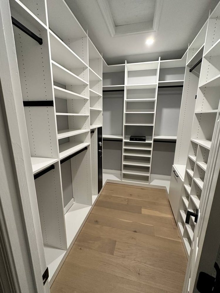 Closet shelving and hanging rods installed along a finished wall