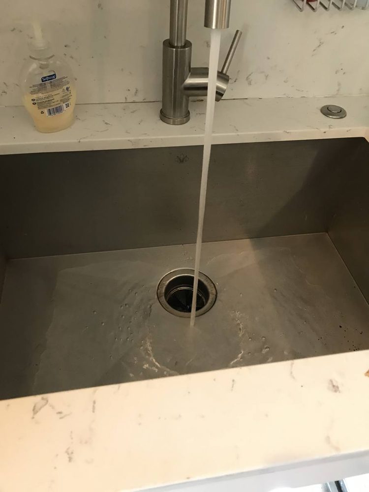 Sink drain running clear after the line was cleared, after the work