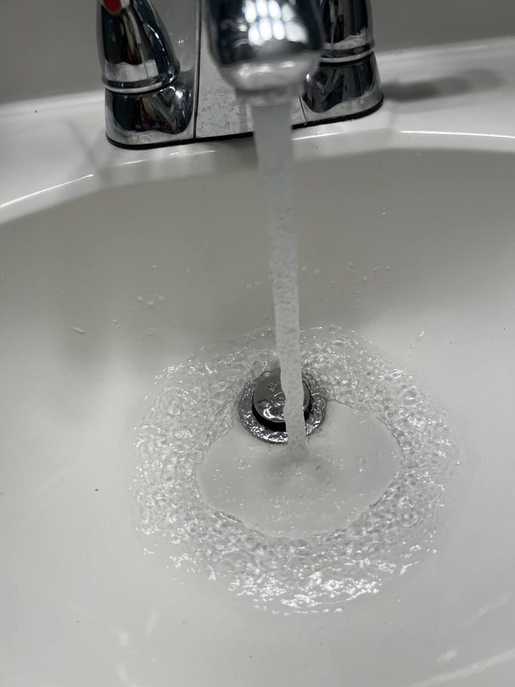 Sink drain running clear after the line was cleared, after the work