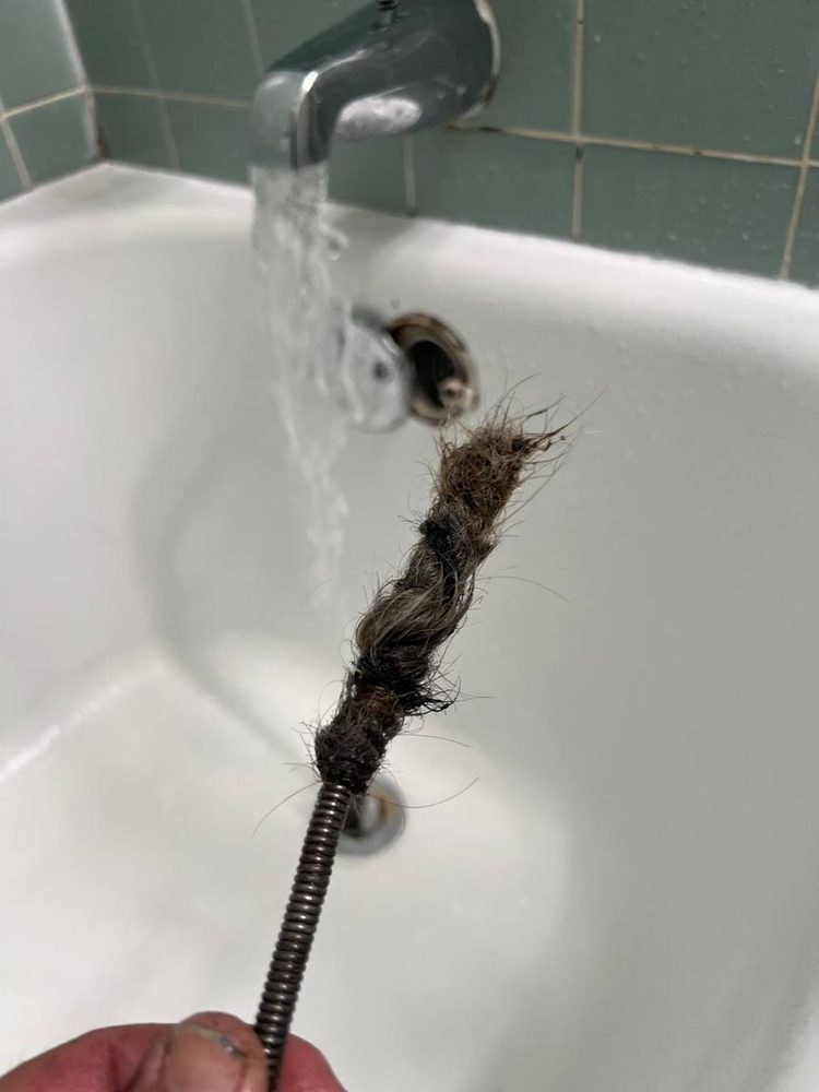 Sink drain running clear after the line was cleared, before the work