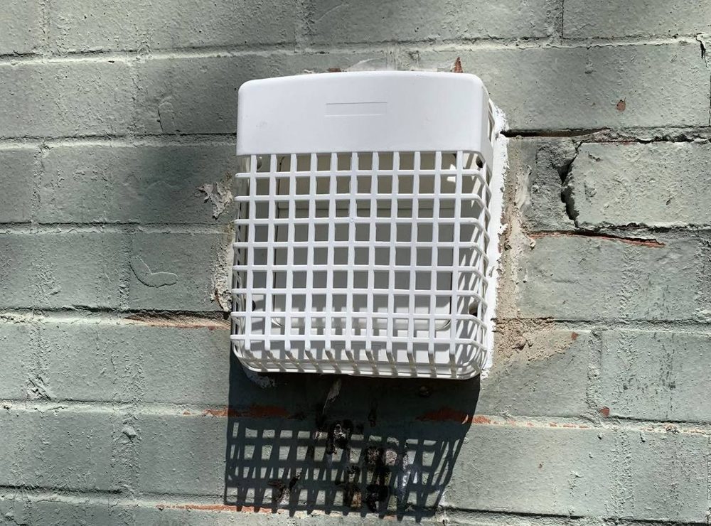 Exterior dryer vent hood and wall penetration, after the work