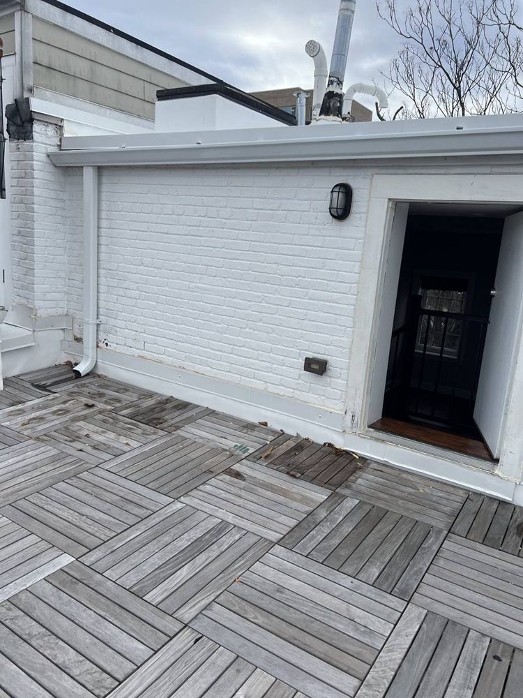 Exterior foundation and siding repainted on a residential home