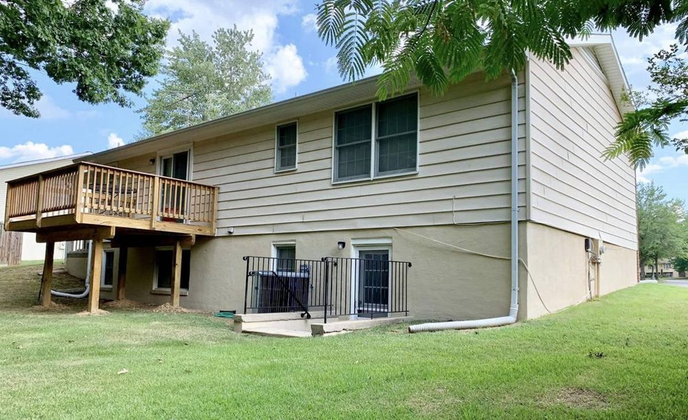 Exterior foundation and siding repainted on a residential home, after the work