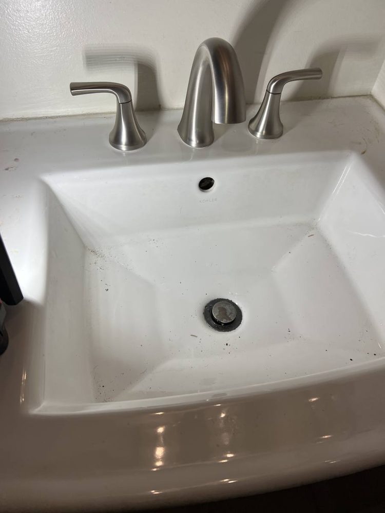 Bathroom faucet installed on a sink, after the work