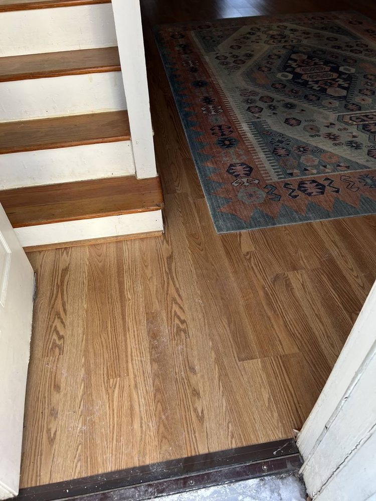 Hardwood flooring repaired and refinished in a residential room