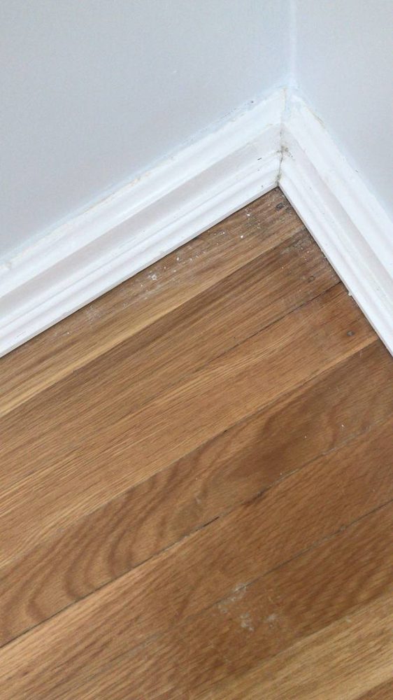 Hardwood flooring repaired and refinished in a residential room