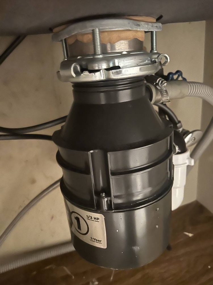 Garbage disposal unit installed under a kitchen sink