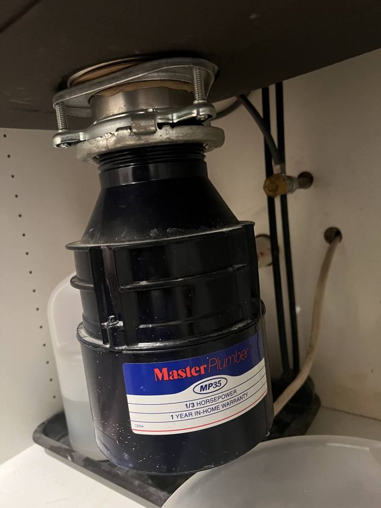 Garbage disposal unit installed under a kitchen sink