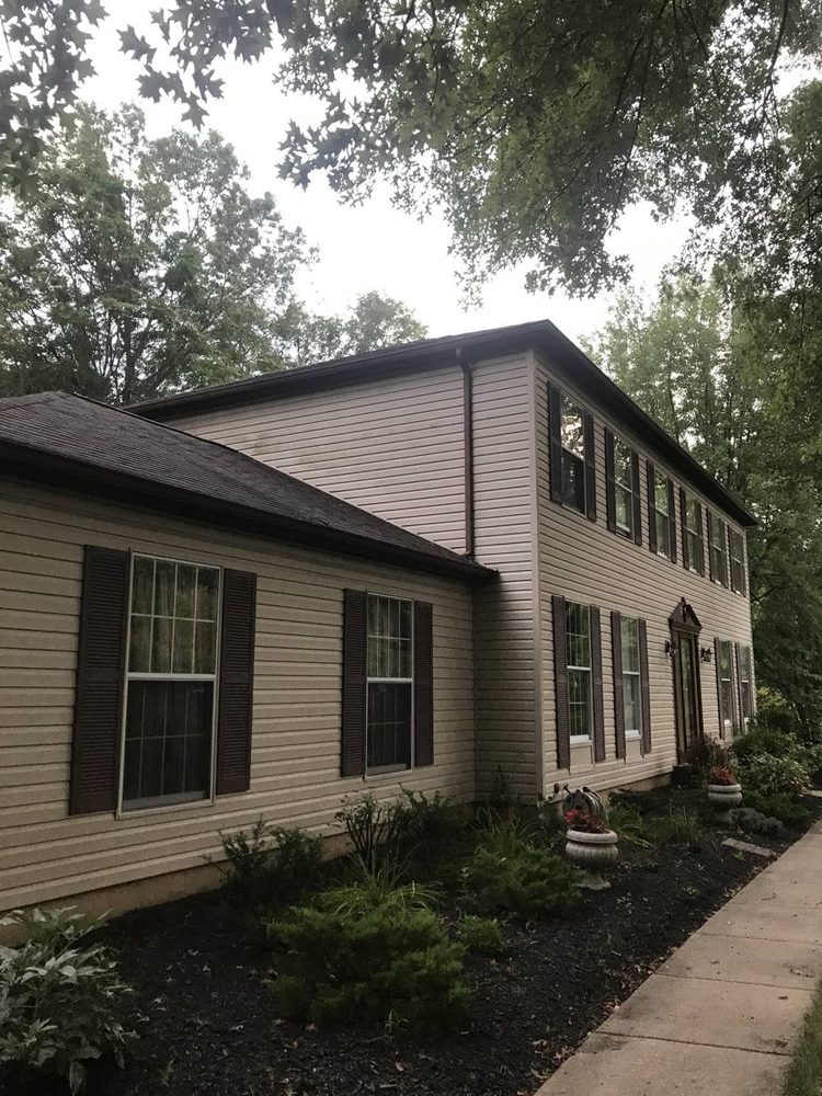 Gutter and downspout repaired on a residential roofline