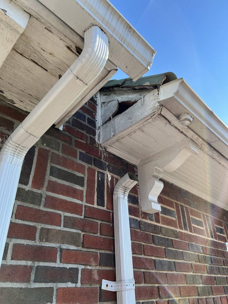 Gutter and downspout repaired on a residential roofline, after the work