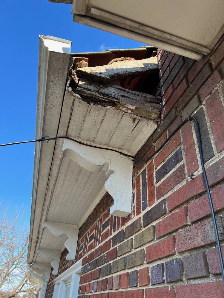 Gutter and downspout repaired on a residential roofline, before the work