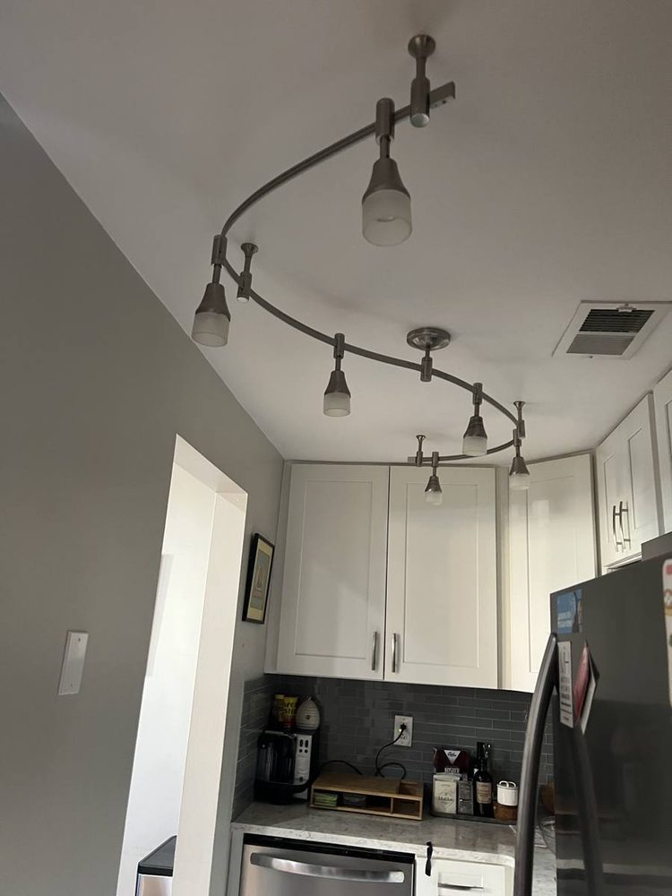 Light fixture mounted and wired to a ceiling, after the work