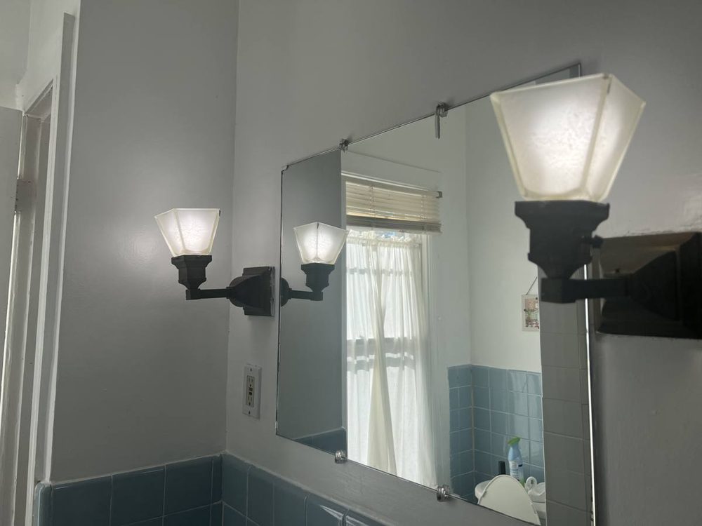 Wall mirror mounted above a bathroom vanity