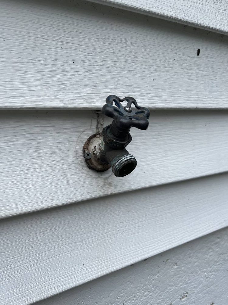 Replacement outdoor hose spigot installed on exterior siding