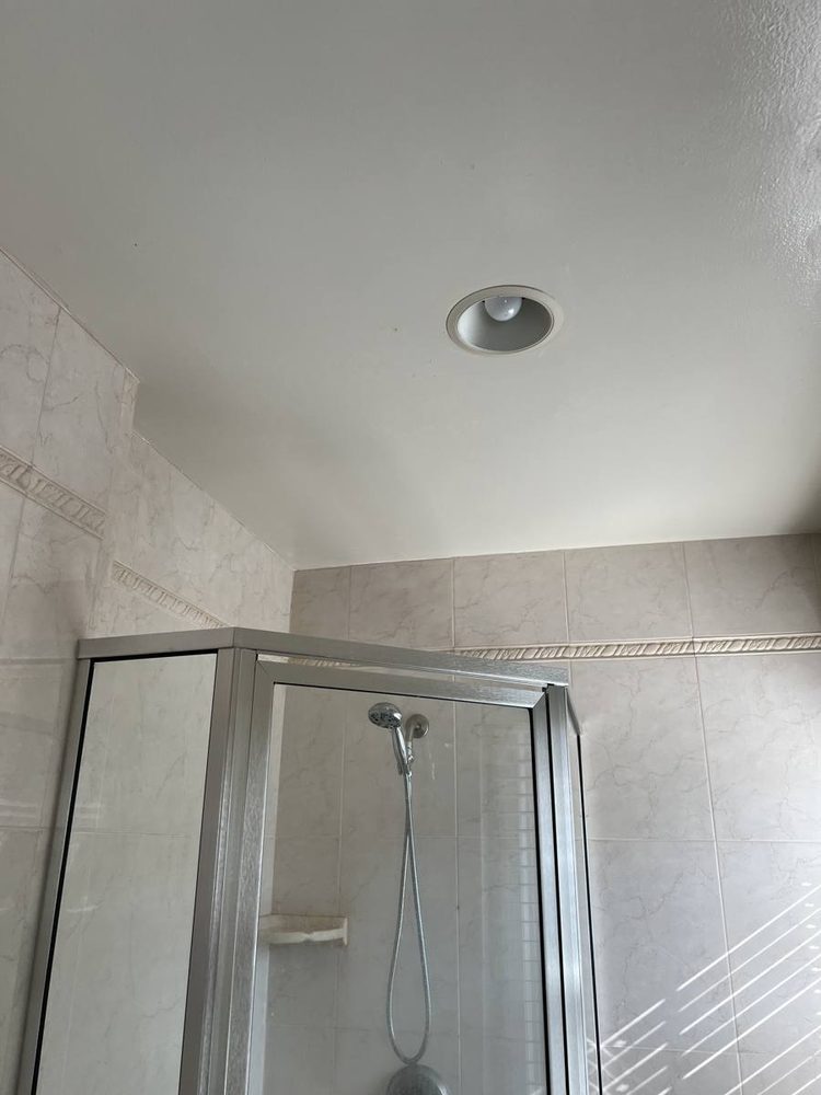 Glass shower door and enclosure fitted to a tiled shower