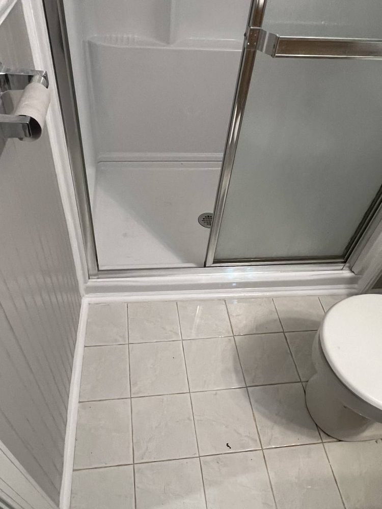 Glass shower door and enclosure fitted to a tiled shower