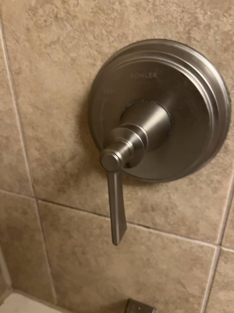 Shower and tub valve trim installed on a finished wall