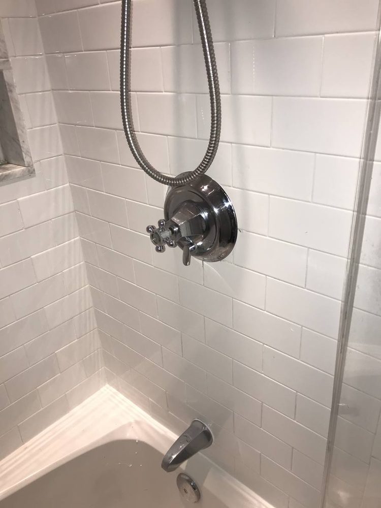 Shower and tub valve trim installed on a finished wall, after the work