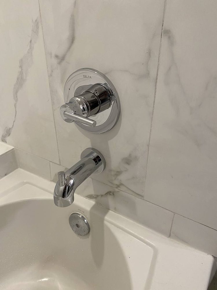 Shower and tub valve trim installed on a finished wall