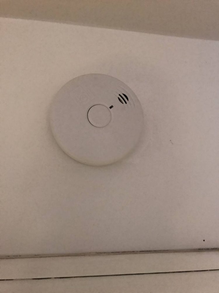 Smoke and carbon monoxide detector mounted to a ceiling
