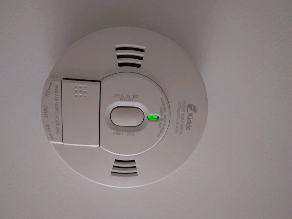 Smoke and carbon monoxide detector mounted to a ceiling