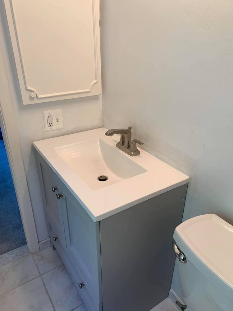 Bathroom vanity and sink installed and plumbed, after the work